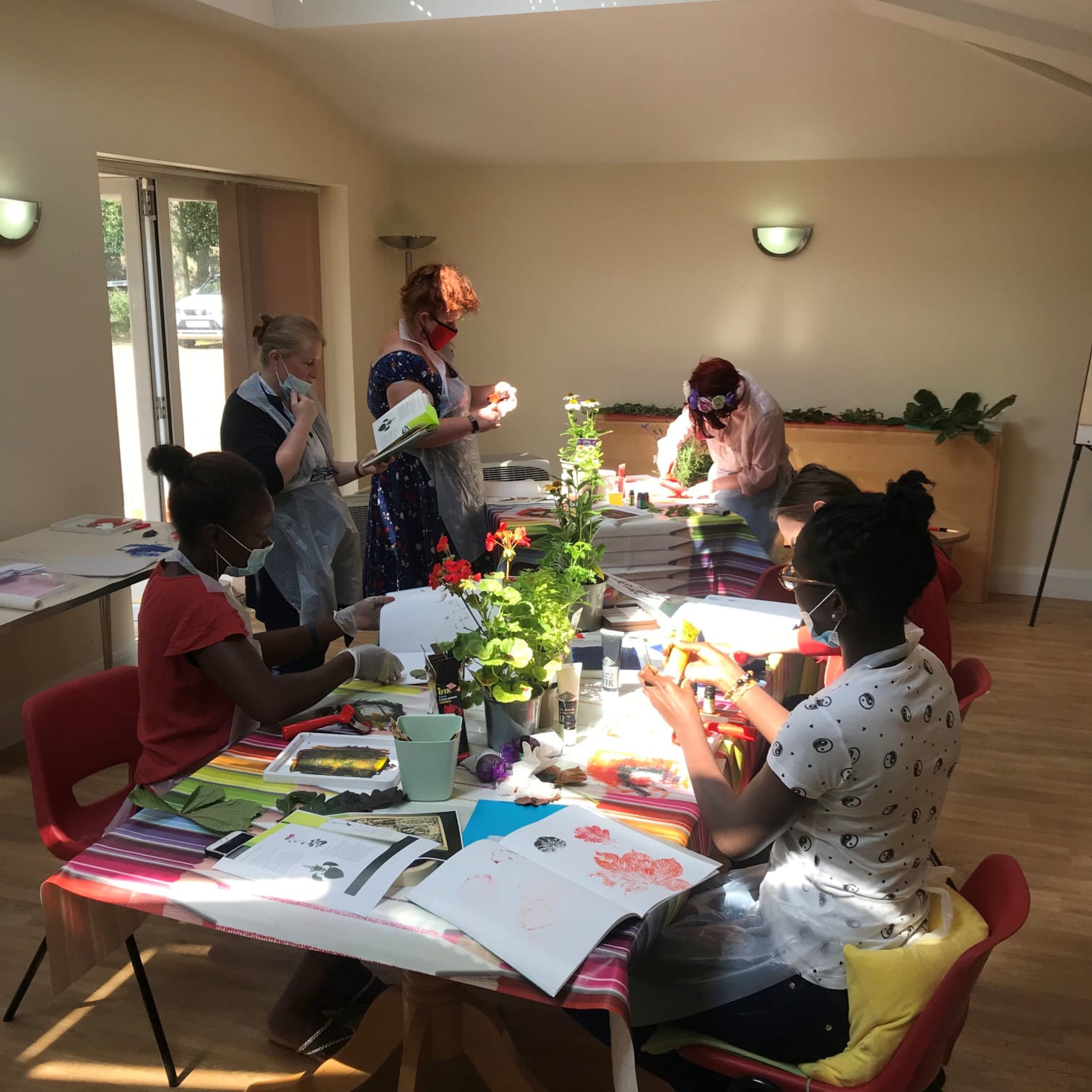 Group of young people making nature inspired artwork in the CABS therapy room
